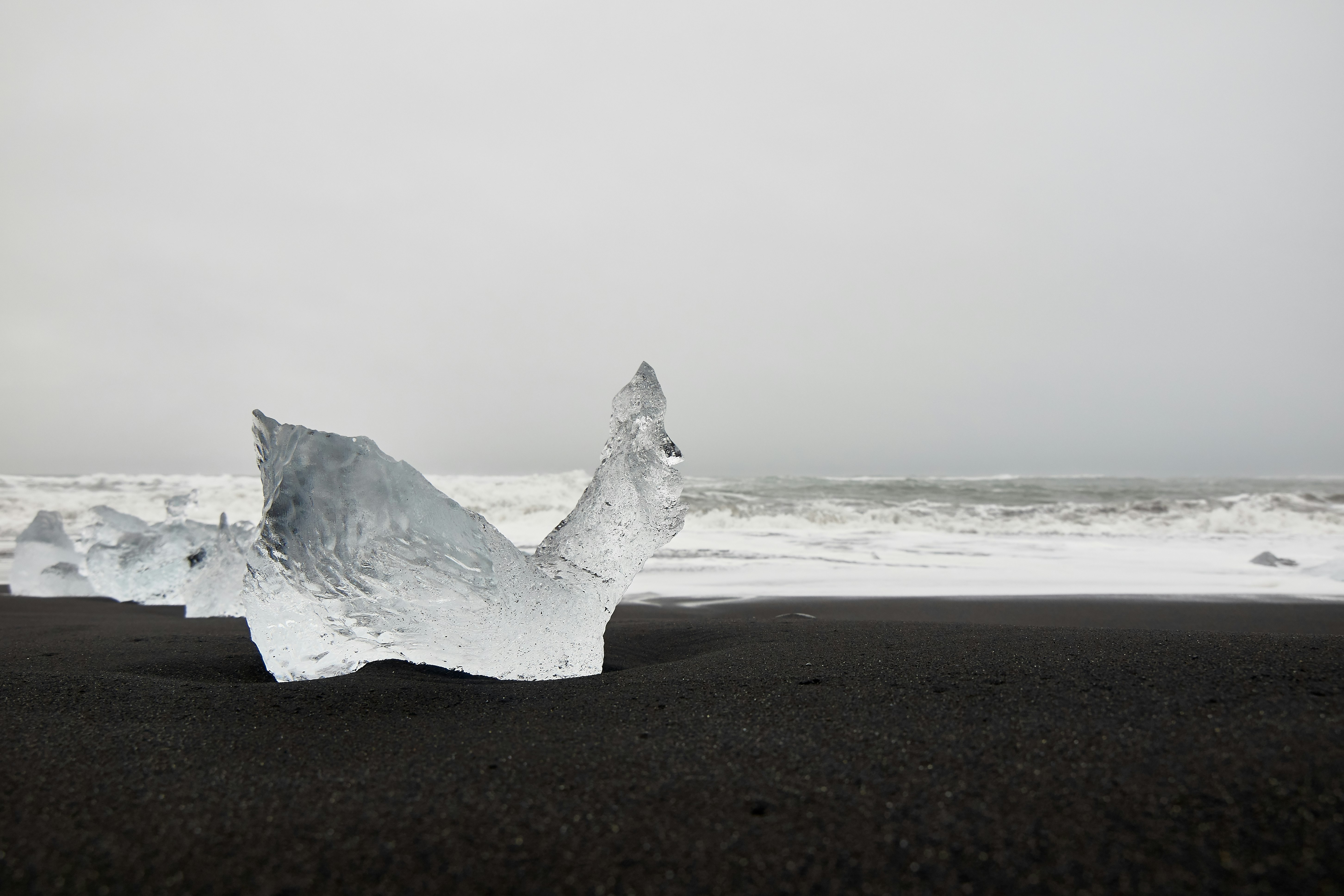 ice on black beach sand